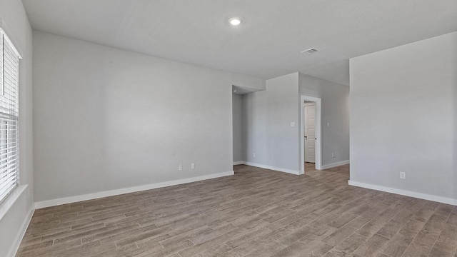 unfurnished room with plenty of natural light and light hardwood / wood-style floors