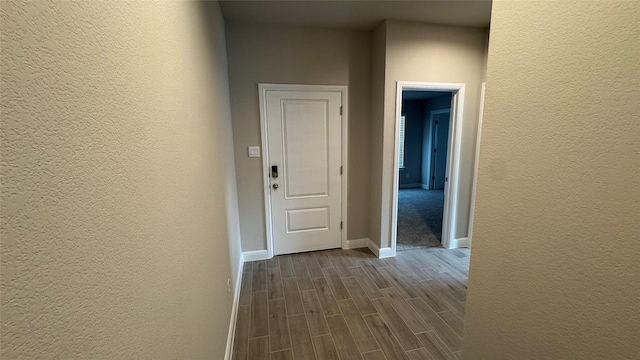 1749 River Bend Rd, Burleson, TX 76028 - hallway featuring a textured wall, dark wood-style floors, and baseboards