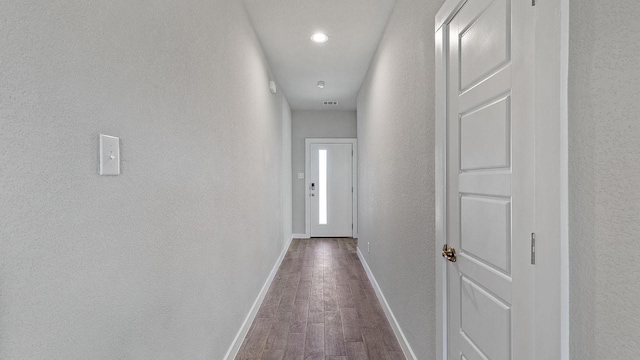 hall with hardwood / wood-style flooring