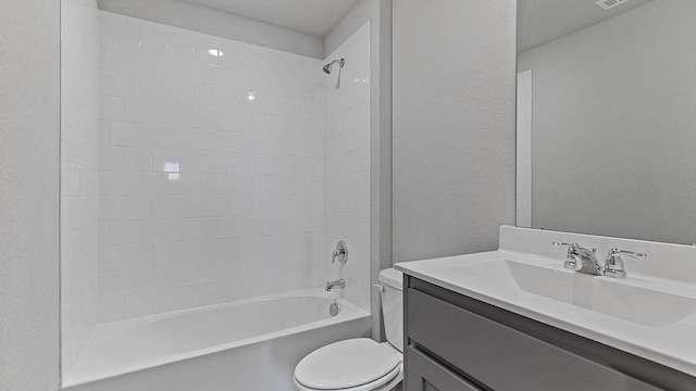 full bathroom featuring vanity, toilet, and tiled shower / bath combo