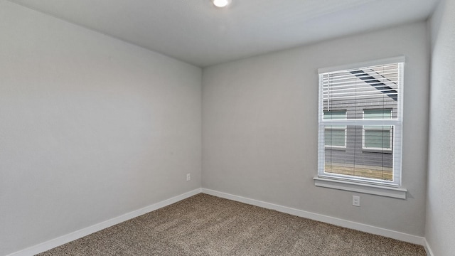 carpeted spare room featuring a healthy amount of sunlight