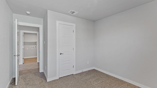 unfurnished bedroom featuring light carpet