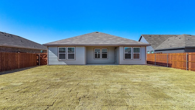 back of house featuring a patio and a lawn