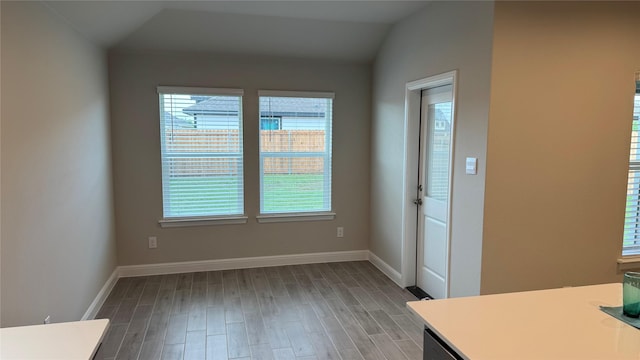 1749 River Bend Rd, Burleson, TX 76028 - unfurnished dining area featuring healthy amount of natural light, wood finished floors, baseboards, and lofted ceiling