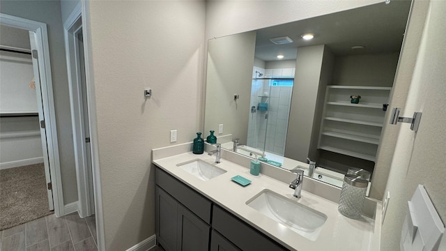 1749 River Bend Rd, Burleson, TX 76028 - full bathroom with double vanity, a stall shower, a spacious closet, and wood finished floors