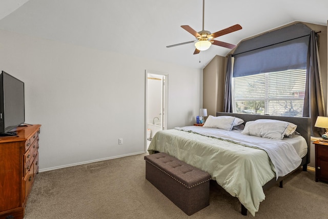 carpeted bedroom with lofted ceiling, ceiling fan, and ensuite bath