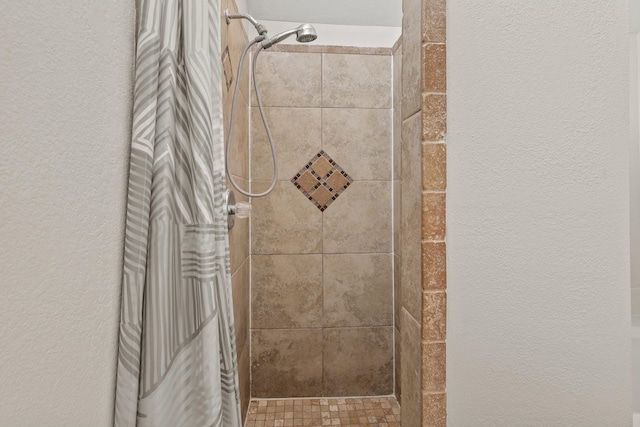 bathroom with tiled shower