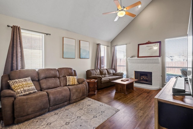 living room featuring ceiling fan, a fireplace, dark hardwood / wood-style floors, and high vaulted ceiling