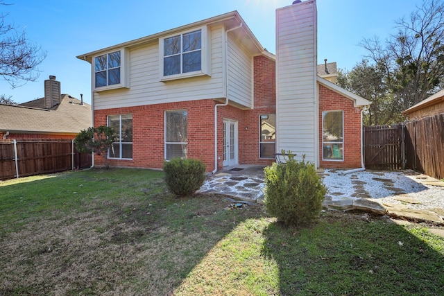 rear view of property with a yard, a patio, and french doors