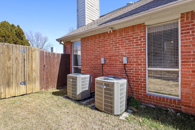 exterior space with a yard and central AC