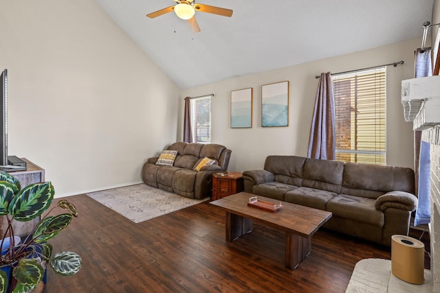 living room with ceiling fan, dark wood-type flooring, a healthy amount of sunlight, and vaulted ceiling