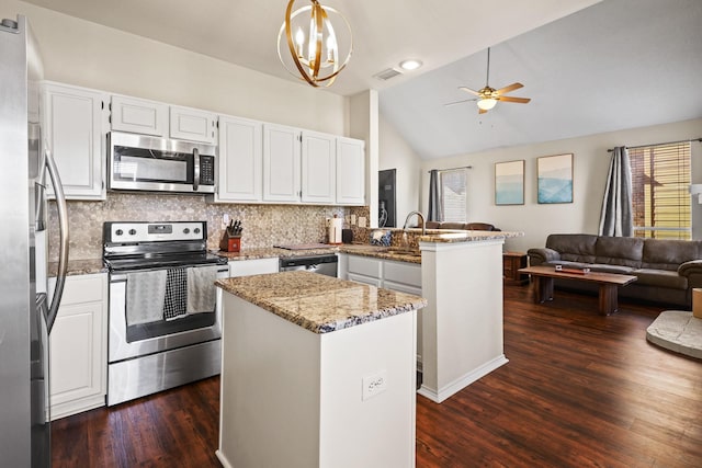 kitchen featuring a kitchen island, appliances with stainless steel finishes, white cabinets, hanging light fixtures, and kitchen peninsula