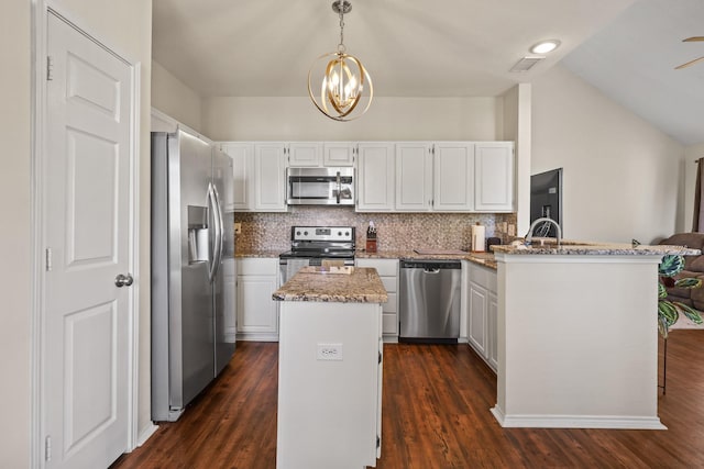 kitchen featuring a kitchen island, white cabinets, hanging light fixtures, kitchen peninsula, and stainless steel appliances