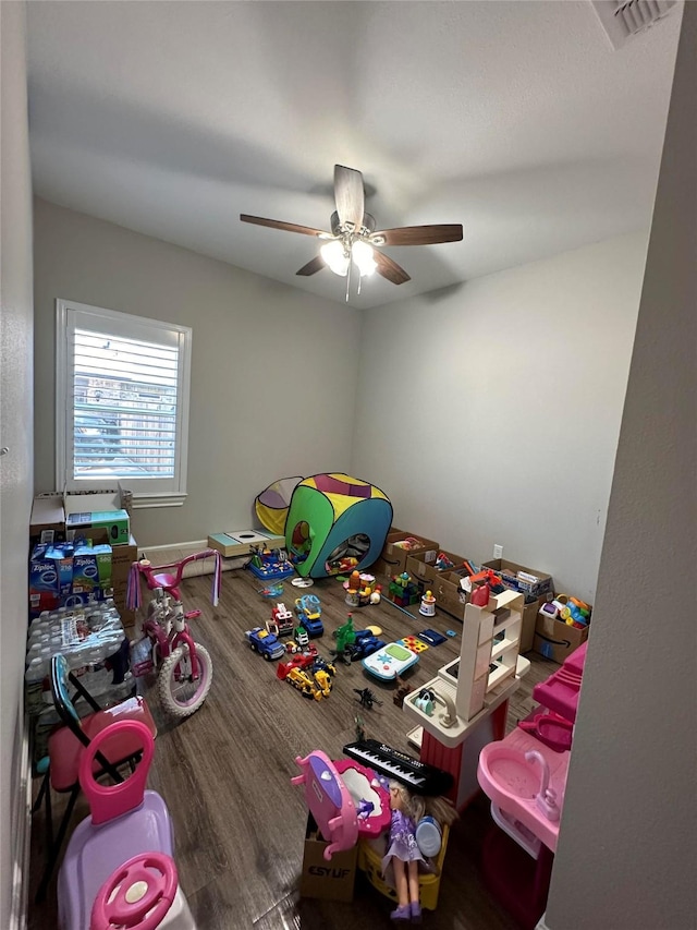 playroom featuring hardwood / wood-style flooring and ceiling fan