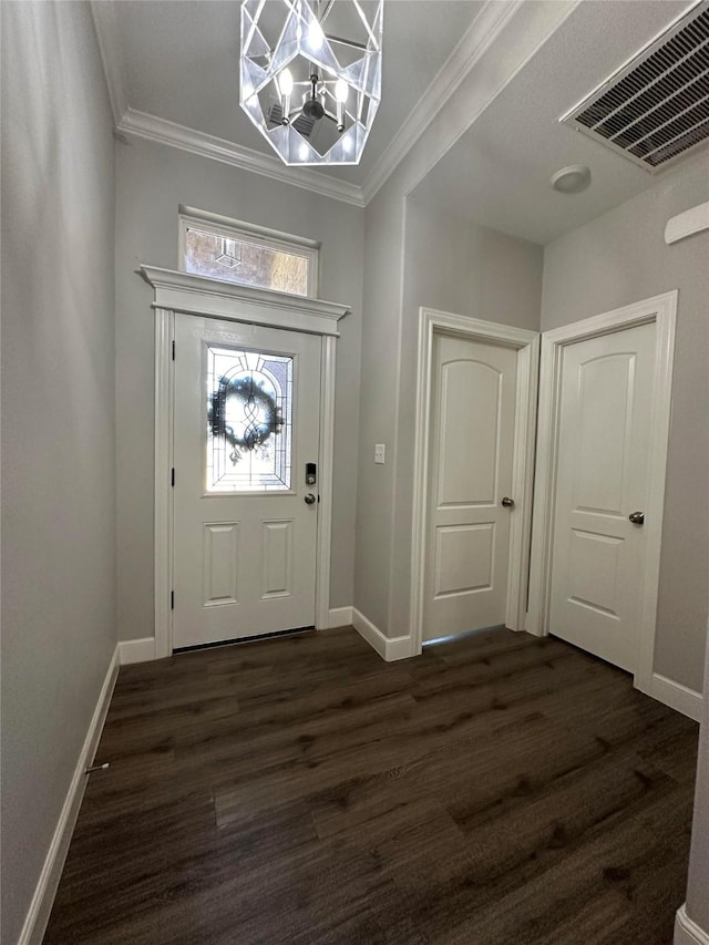 foyer featuring crown molding, dark hardwood / wood-style floors, and a notable chandelier