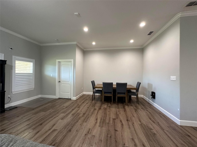 dining room featuring dark wood-type flooring and ornamental molding