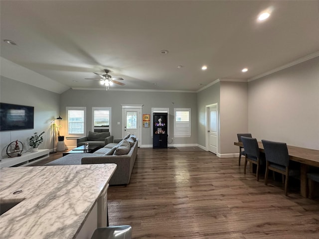 living room with dark hardwood / wood-style flooring, vaulted ceiling, ornamental molding, and ceiling fan