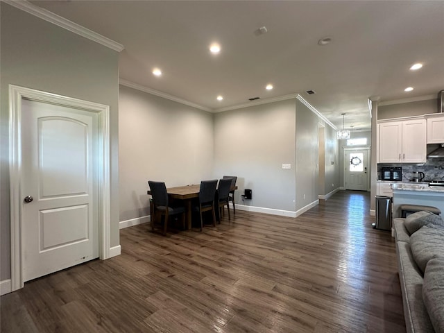 dining room with crown molding and dark hardwood / wood-style floors