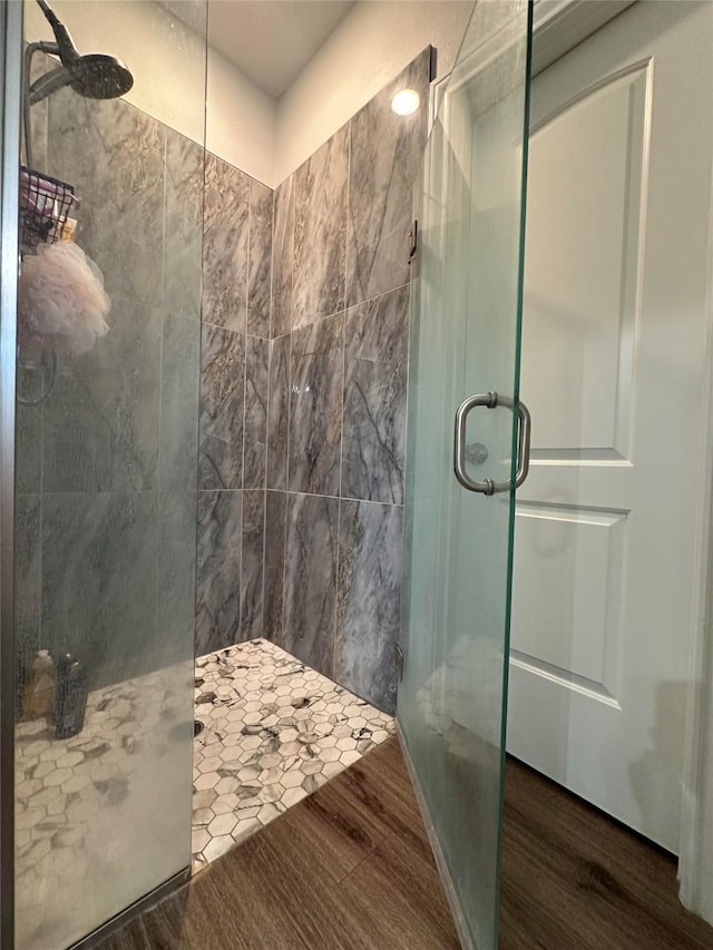 bathroom featuring hardwood / wood-style floors and walk in shower