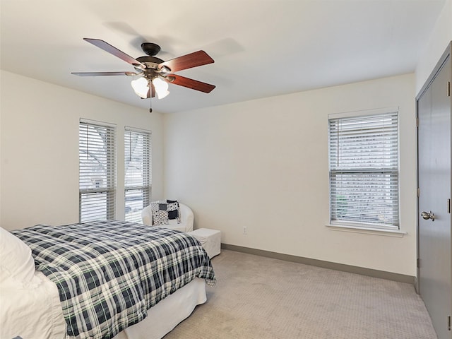 bedroom with light carpet, a closet, and ceiling fan