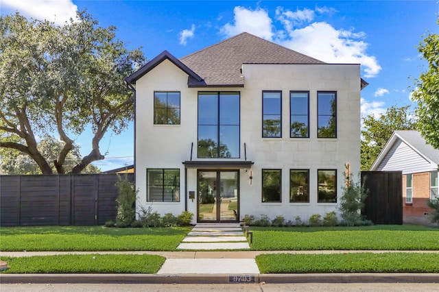 contemporary home featuring a front yard and french doors