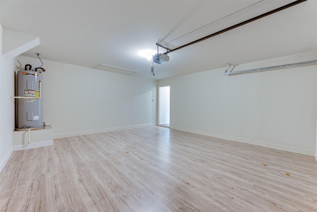 garage with a garage door opener and electric water heater