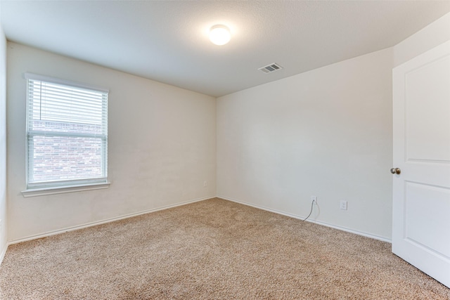 unfurnished room featuring light colored carpet