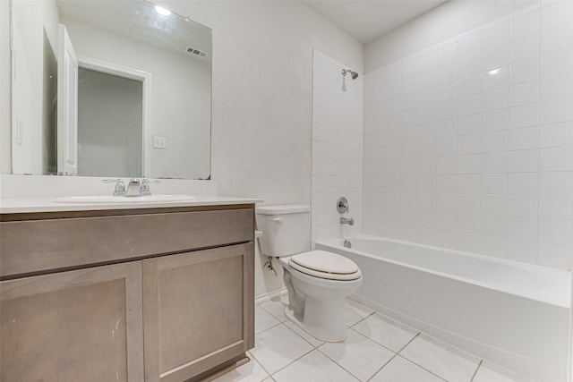 full bathroom featuring tile patterned flooring, vanity, toilet, and tiled shower / bath