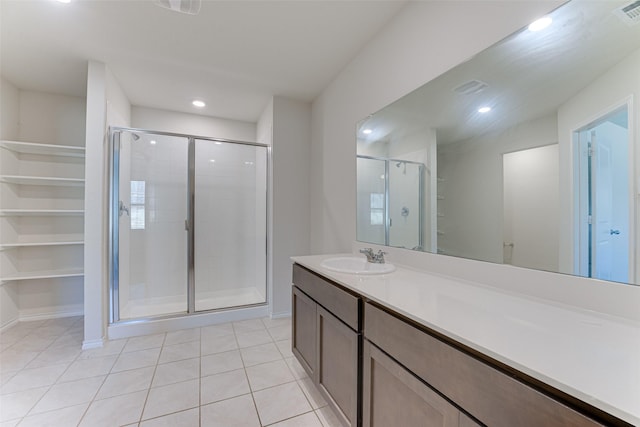 bathroom with vanity, tile patterned floors, and a shower with shower door