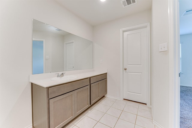 bathroom with tile patterned flooring and vanity