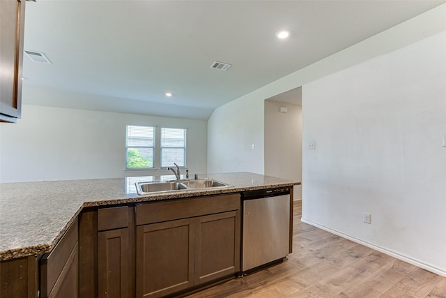 kitchen with stone countertops, dishwasher, sink, and light hardwood / wood-style flooring