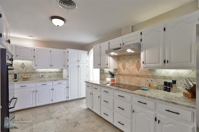 kitchen with black electric cooktop, backsplash, light stone counters, and white cabinets