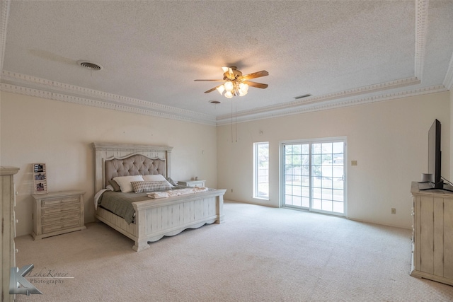 bedroom with crown molding, light carpet, ceiling fan, and a textured ceiling