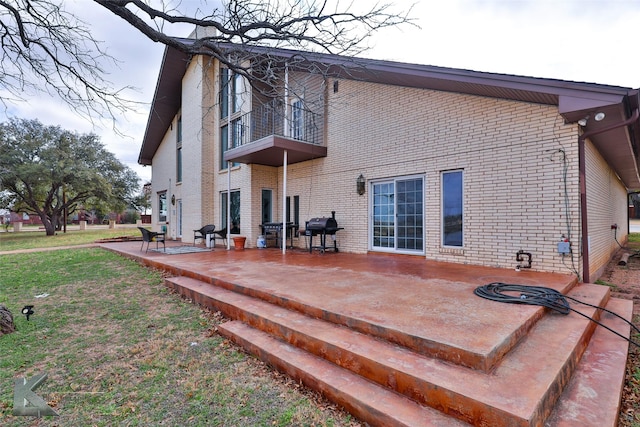 back of house with a balcony and a patio