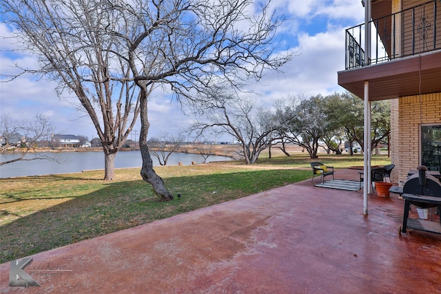 view of patio / terrace with grilling area and a water view