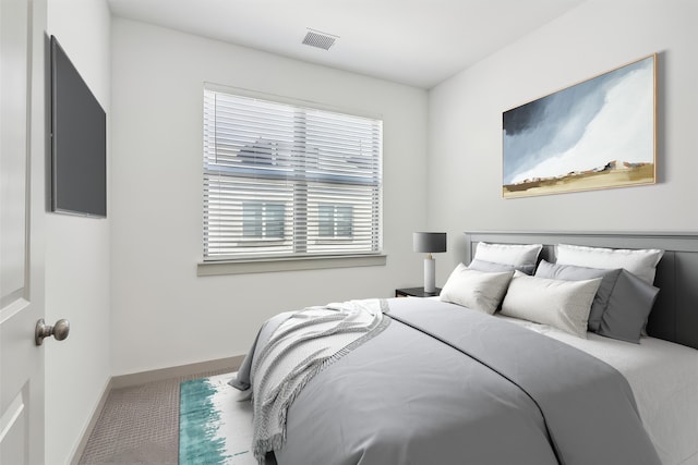 carpeted bedroom featuring visible vents and baseboards