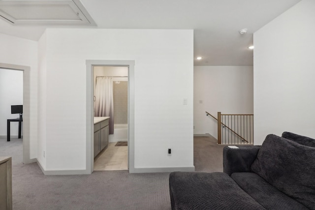 living room featuring light colored carpet and baseboards