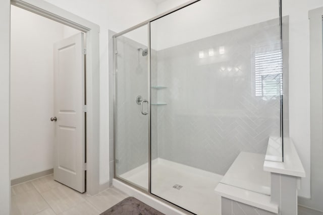 full bathroom with a stall shower and tile patterned flooring