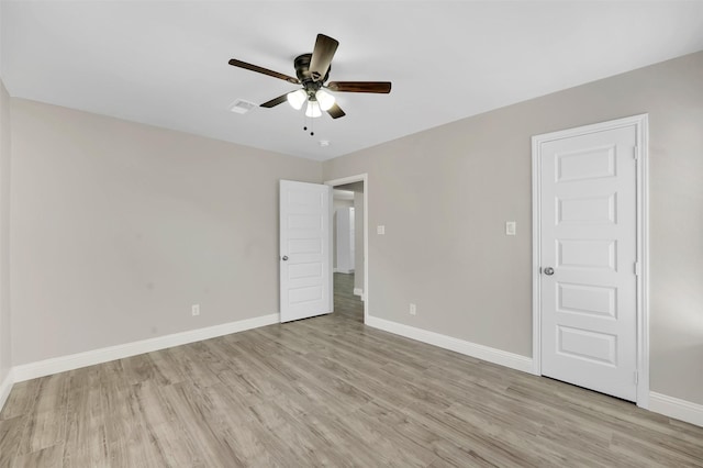 unfurnished room with ceiling fan and light wood-type flooring