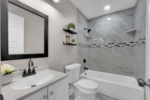 full bathroom with vanity, tiled shower / bath combo, and toilet