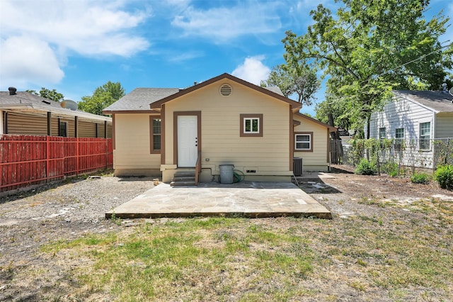 rear view of property with a yard and a patio area