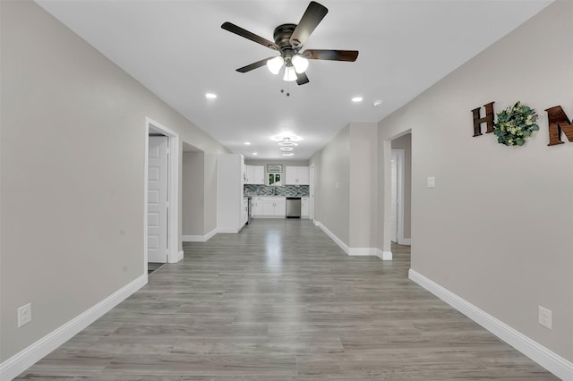 hallway with light hardwood / wood-style floors