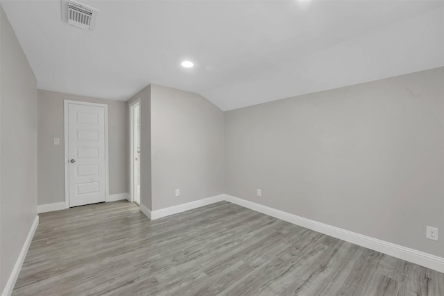 bonus room with lofted ceiling and light hardwood / wood-style flooring