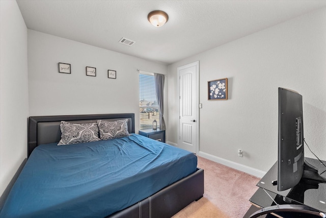 bedroom featuring baseboards, carpet flooring, and visible vents