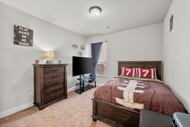 bedroom with baseboards, visible vents, and light carpet