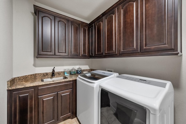 laundry room with cabinets, separate washer and dryer, sink, and light tile patterned floors