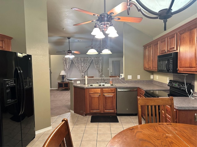 kitchen with light tile patterned floors, kitchen peninsula, sink, and black appliances