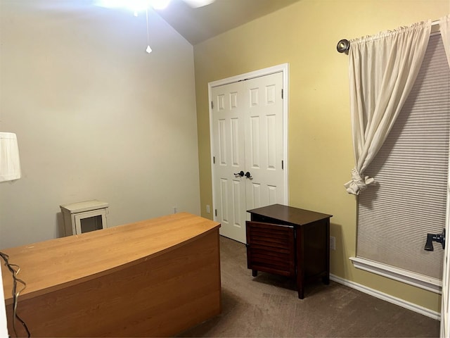 carpeted home office featuring ceiling fan