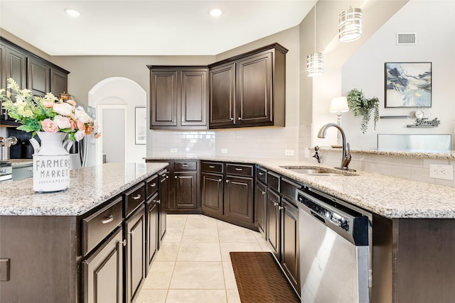 kitchen featuring light tile patterned flooring, sink, dishwasher, pendant lighting, and decorative backsplash