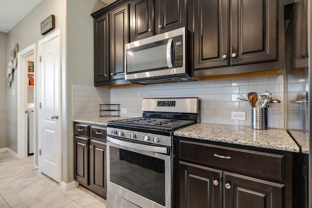 kitchen featuring light stone counters, tasteful backsplash, appliances with stainless steel finishes, and dark brown cabinets